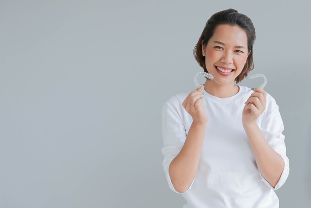 Woman Holding Invisalign Treatment