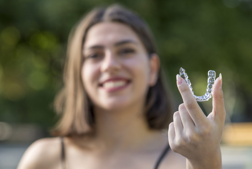 woman holding up the best clear aligner option